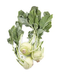 Whole ripe kohlrabies with leaves on white background, top view