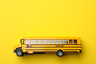 School bus on yellow background, top view with space for text. Transport service