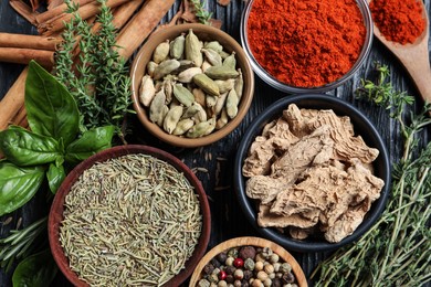 Different natural spices and herbs on table, flat lay