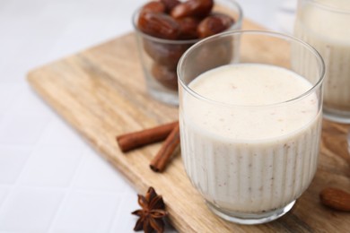 Photo of Glass of delicious date smoothie on white table, closeup. Space for text