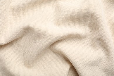 Beige hemp cloth as background, top view. Natural fabric