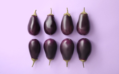 Raw ripe eggplants on light background, flat lay