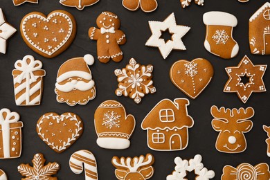Many different delicious Christmas cookies on black table, flat lay