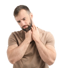 Young man suffering from sore throat on white background