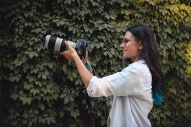 Photo of Beautiful woman with camera spending time in nature reserve