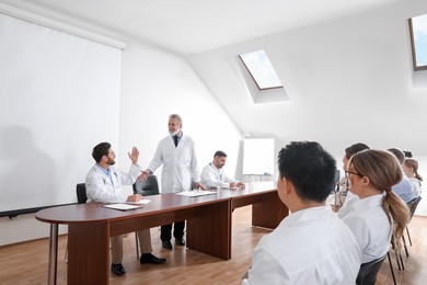 Photo of Doctors having discussion on lecture during medical conference
