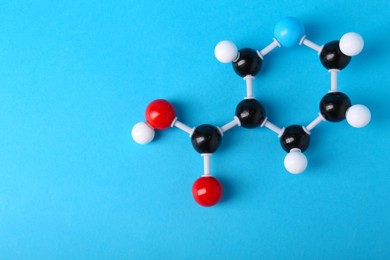 Photo of Molecule of vitamin B3 on light blue background, top view with space for text. Chemical model