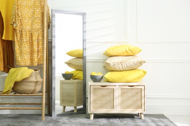 Stylish dressing room with big mirror. Interior design in grey and yellow colors