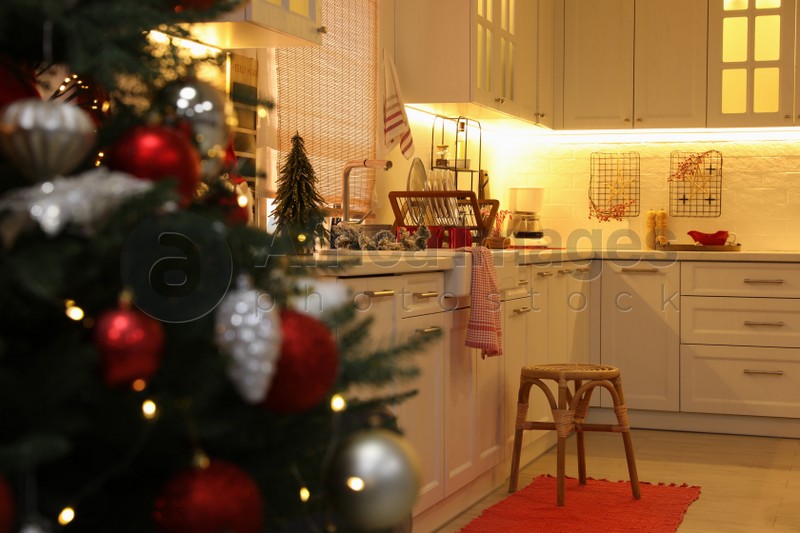 Cozy kitchen interior with Christmas tree and beautiful festive decor