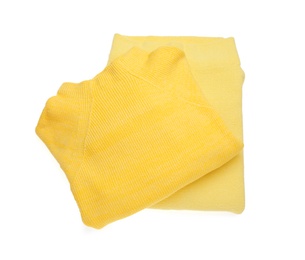 Yellow woolen sweaters on white background, top view