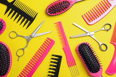 Flat lay composition with professional scissors and other hairdresser's equipment on yellow background. Haircut tool