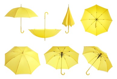 Set with stylish yellow umbrellas on white background