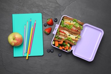 Photo of Flat lay composition with lunch box of tasty healthy food and school stationery on grey table