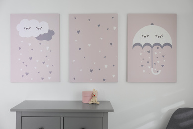 Baby room interior with stylish furniture and cute posters on wall