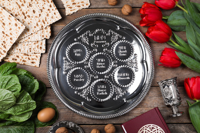 Flat lay composition with Passover Seder plate (keara) on wooden table. Pesah celebration