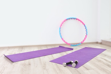 Hula hoop, yoga mats and dumbbells in physiotherapy gym