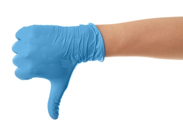 Person in blue latex gloves showing thumb down gesture against white background, closeup on hand