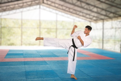 Professional coach showing karate moves at gym