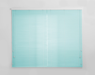 Image of Window with closed turquoise blinds in room