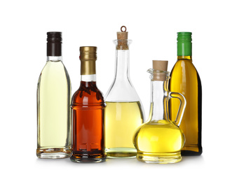 Different sorts of cooking oil in bottles isolated on white