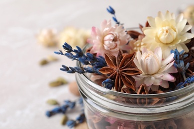 Aroma potpourri with different spices in jar, closeup view. Space for text