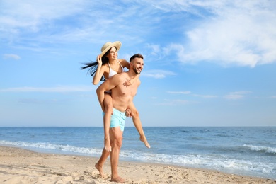 Happy young couple having fun on beach