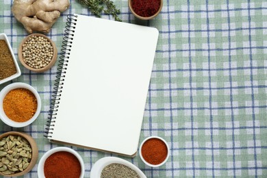 Photo of Blank recipe book and different ingredients on checkered tablecloth, flat lay. Space for text