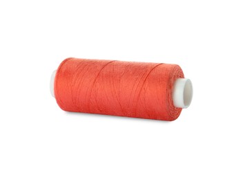 Spool of coral sewing thread isolated on white