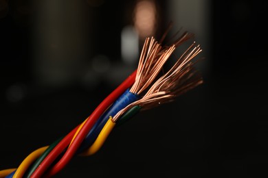 Photo of Electric wires on blurred background, closeup view