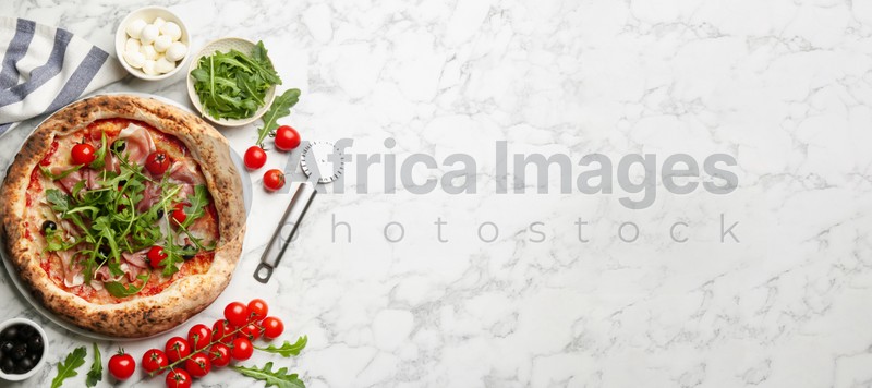 Tasty pizza with meat and arugula on white marble table, flat lay with space for text. Banner design