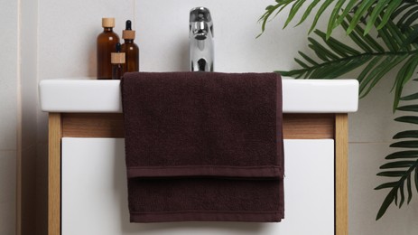 Brown soft towel on sink in bathroom