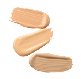 Samples of liquid skin foundations on white background, top view