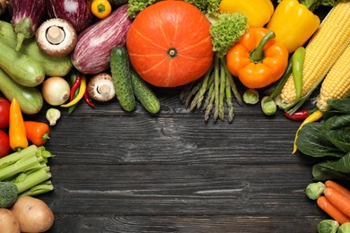 Photo of Different fresh vegetables on black wooden table, flat lay. Space for text