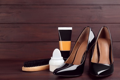Shoe care accessories and footwear on brown wooden table