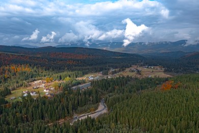 Aerial view of mountain forest and village on autumn day