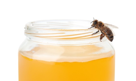 Jar with honey and bee on white background
