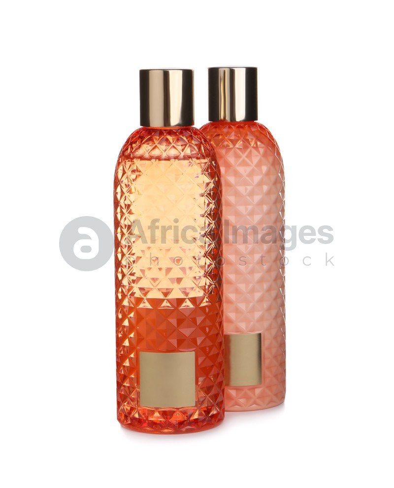 Stylish bottles with cosmetic products on white background