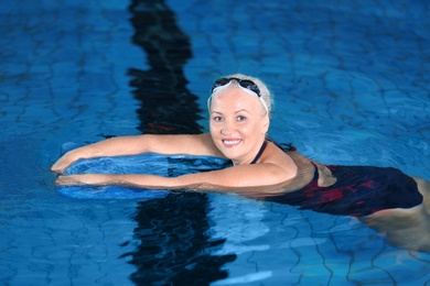 Sportive senior woman in indoor swimming pool