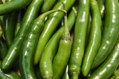 Photo of Green hot chili peppers as background, closeup