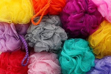Many colorful shower puffs as background, closeup