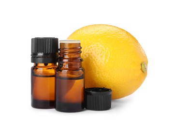 Bottles of citrus essential oil and fresh lemon isolated on white