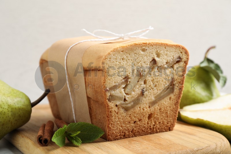 Tasty pear bread on wooden board, closeup. Homemade cake