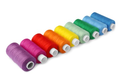 Set of different colorful sewing threads on white background
