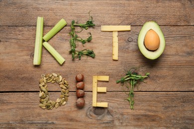 Phrase Keto Diet made with different products on wooden table, flat lay