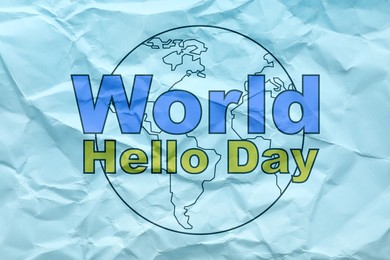 Image of Phrase World Hello Day and image of Earth on crumpled light blue paper