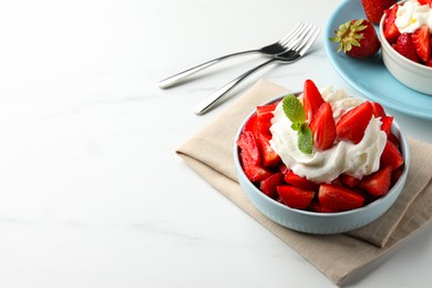 Delicious strawberries with whipped cream served on white table. Space for text