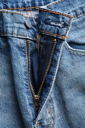 Blue jeans with unbuttoned fly as background, top view. Exhibitionist concept