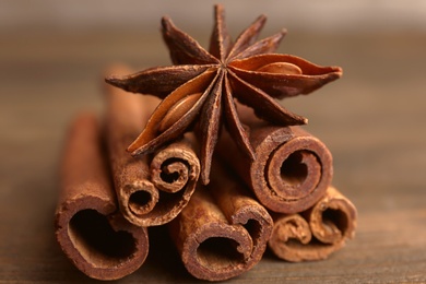 Cinnamon sticks with anise on wooden table