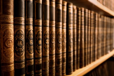 Collection of old books on shelf in library, closeup