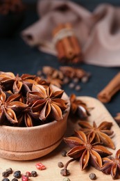 Photo of Aromatic anise stars and spices on tray, closeup